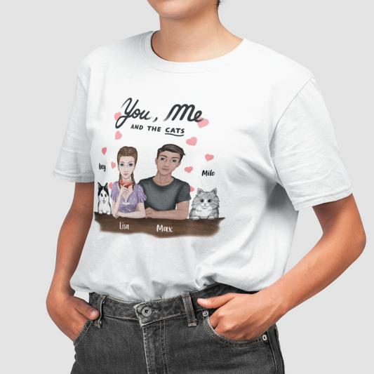 Woman wearing a t-shirt with the 'You, Me AND THE CATS' design, showcasing personalized woman and man characters along with two selected cat images, each accompanied by a custom name.