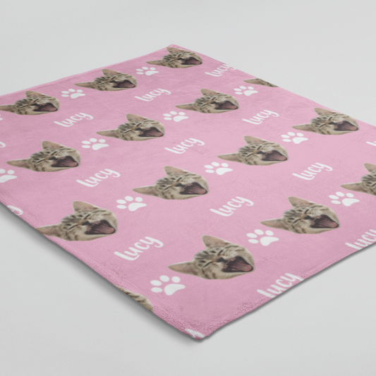 Blanket displaying a custom chosen cat head design and personalized name below it.