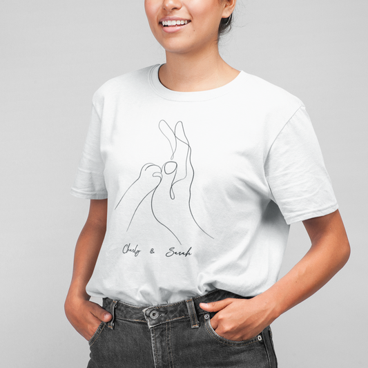 Woman wearing a white Human & Cat Paw T-Shirt featuring a custom design of a cat paw and human hand holding each other, symbolizing the bond between pet and owner.