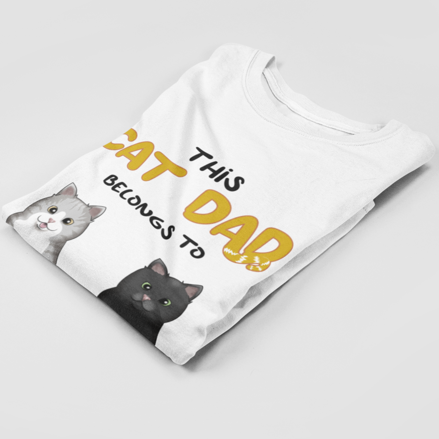 Folded Personalized Cat Dad T-Shirt showcasing unique cat motif print.