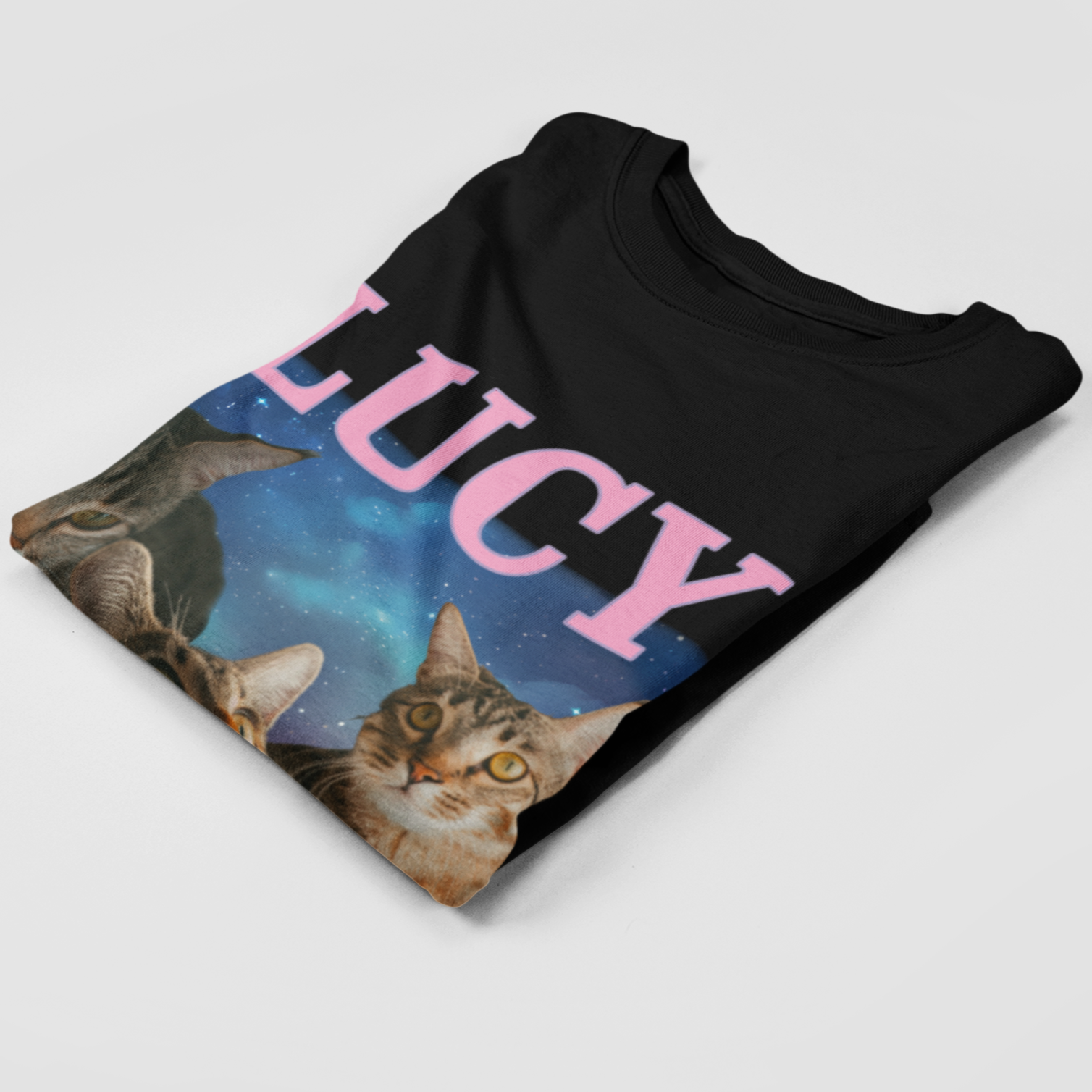 Folded t-shirt revealing six custom cat images, each with its corresponding name labeled above.