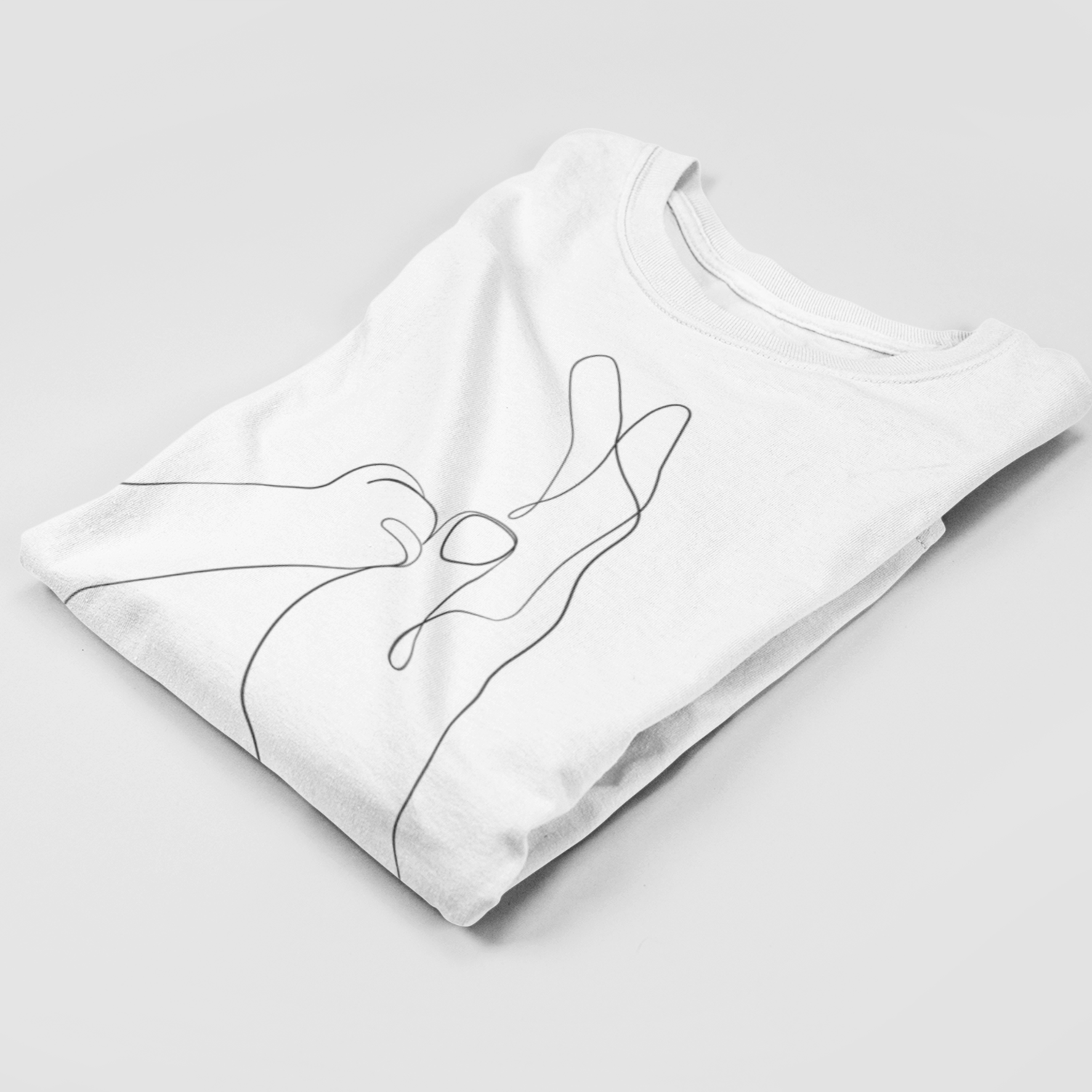 Folded white Human & Cat Paw T-Shirt showcasing the touching cat paw and human hand design, neatly prepared for presentation or as a thoughtful gift.