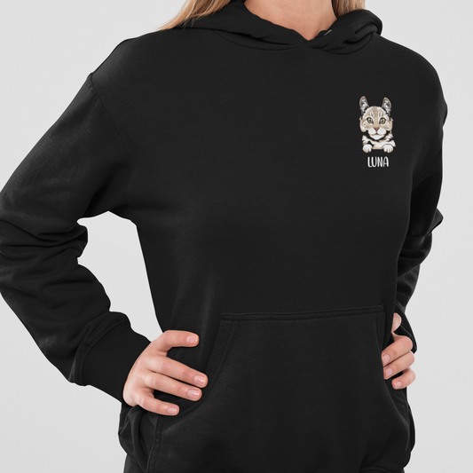 Woman wearing a hoodie featuring a peeking cat head design with a personalized name below.