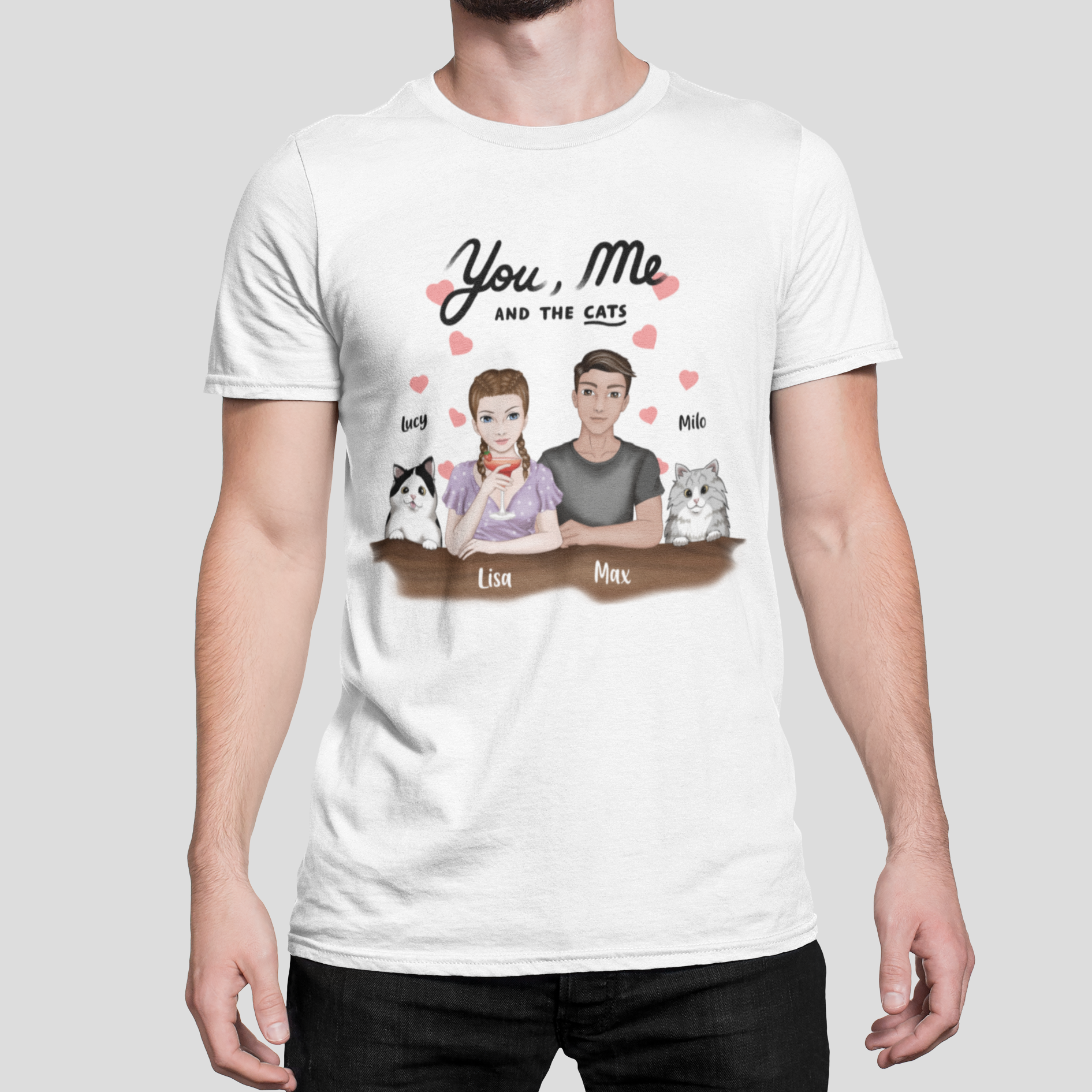 Man wearing a t-shirt featuring the 'You, Me AND THE CATS' design with personalized woman and man characters and two custom cat images, each with their chosen name above.