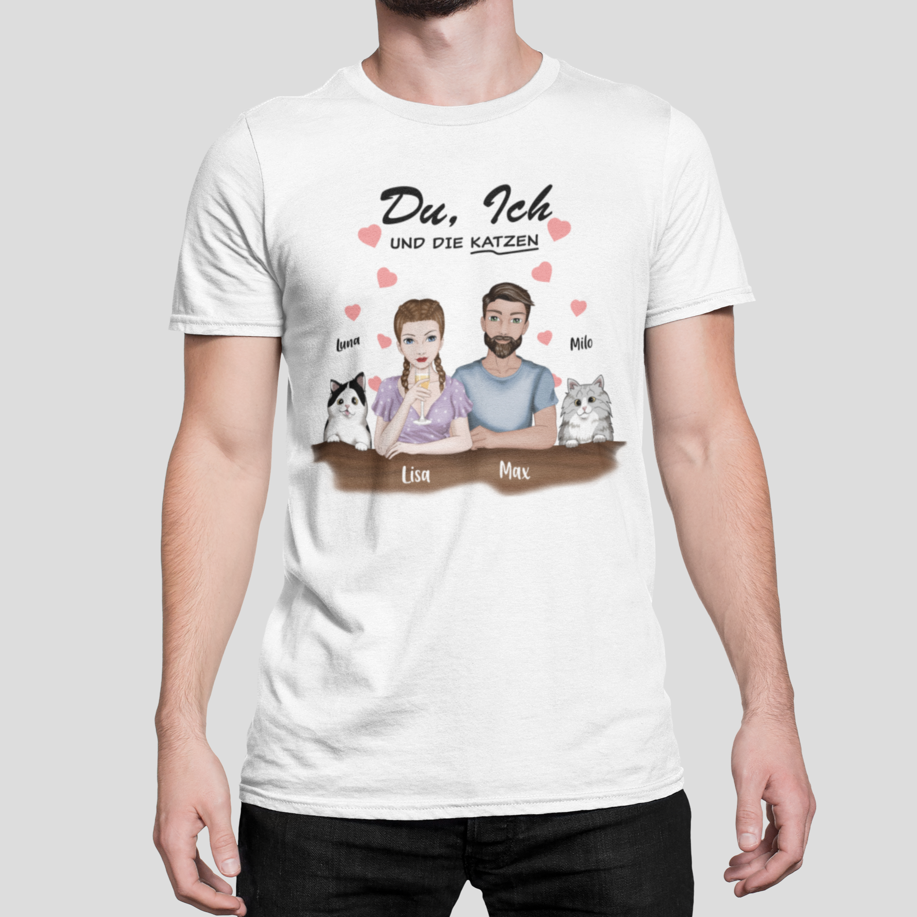  "Man wearing a t-shirt featuring the 'Du, ich und die Katzen' design with personalized woman and man characters and two custom cat images, each with their chosen name above.